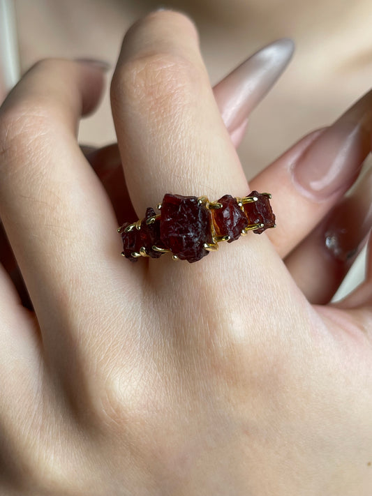 Raw garnet ring worn close up detail
