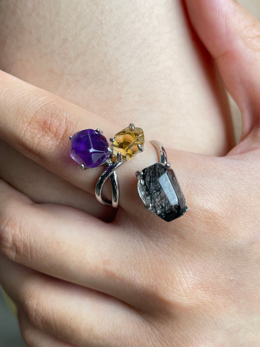 Close up of amethyst, citrine and black tourmalinated quartz freeform ring worn on hand