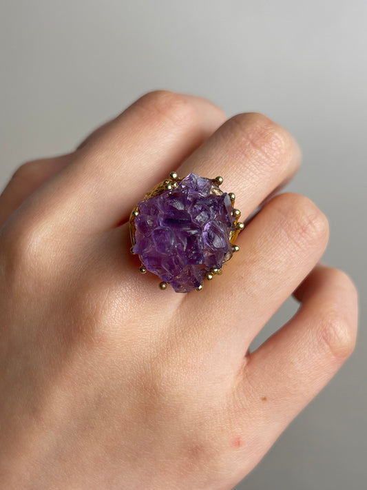 Close up of amethyst cluster raw crystal bouquet ring worn on hand