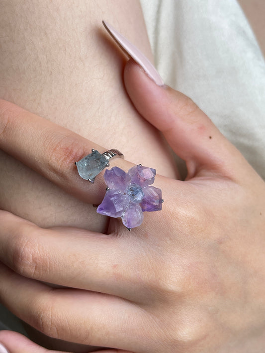 Amethyst flower and Aquamarine raw crystal ring worn on hand close up