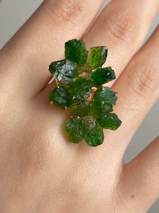Close-up of Chrome Diopside and Citrine raw crystal floral ring worn on hand