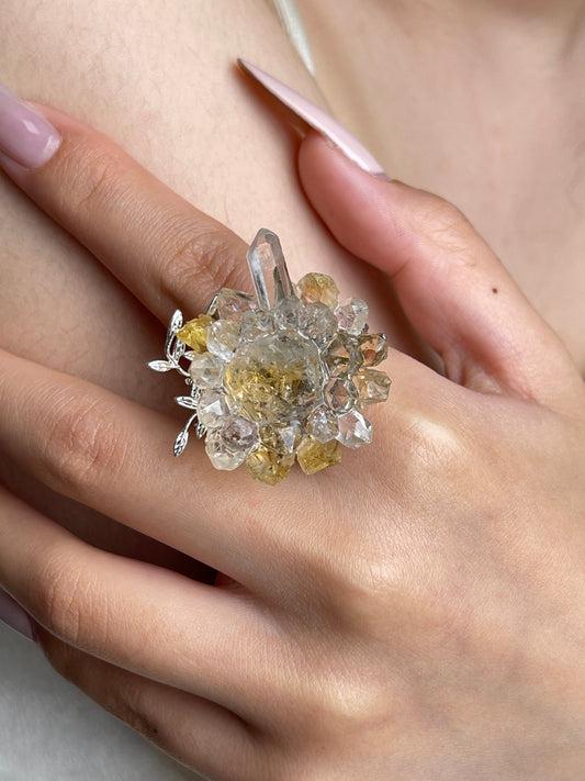 Close up of citrine Herkimer Diamond Quartz and Lemurian seed quartz flower ring worn on hand
