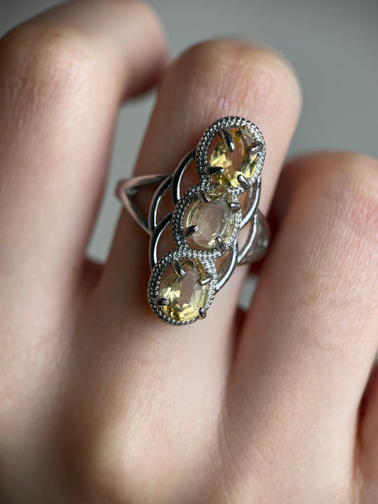 close up of citrine pear cut ring showing golden light reflection