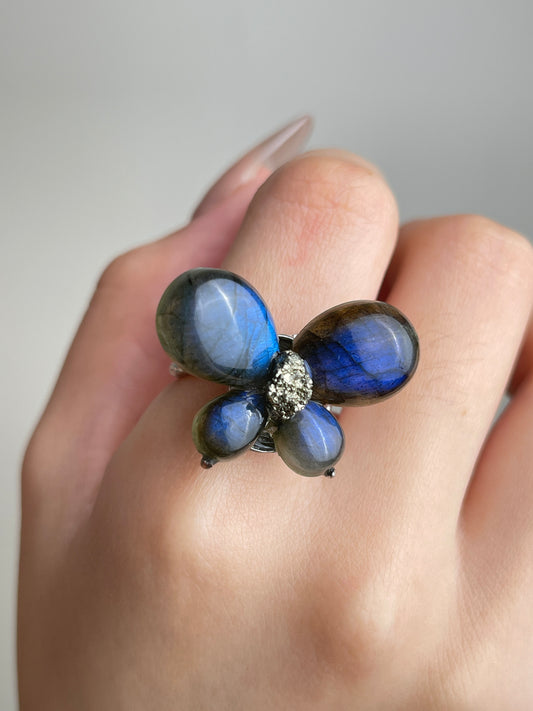 Close-up hand view of Labradorite Butterfly Ring with raw Chalcopyrite