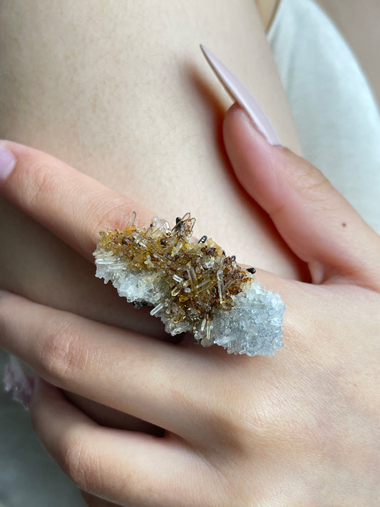 Close-up of Needle Quartz Cluster mineral specimen ring worn on hand