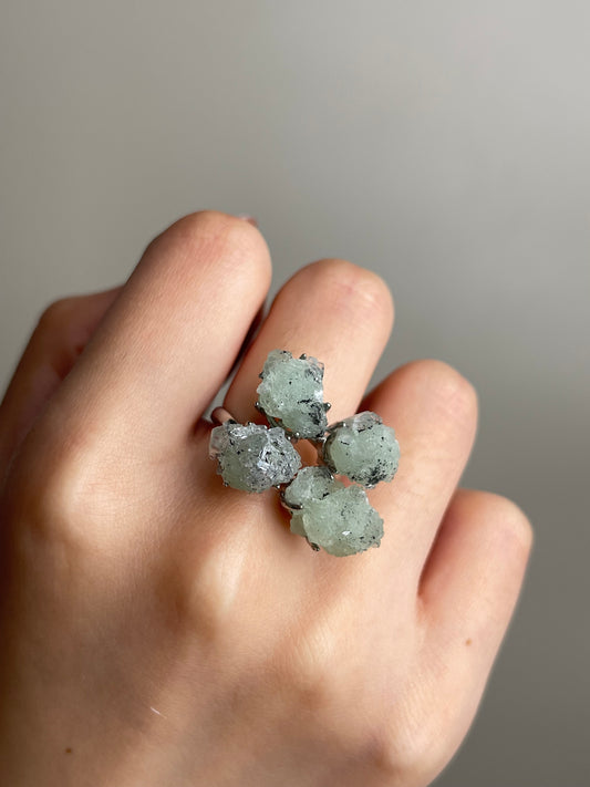 Close-up hand shot of Green Prehnite, Quartz and Magnetite Mineral Specimen Ring showing natural crystal details