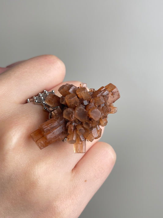 Close-up hand shot of Moroccan Aragonite Mineral Specimen Ring showing raw crystal cluster detail