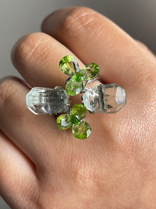 close up look peridot flower ring with green quartz