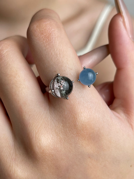 Close-up hand shot of Phantom Quartz and Aquamarine sphere ring