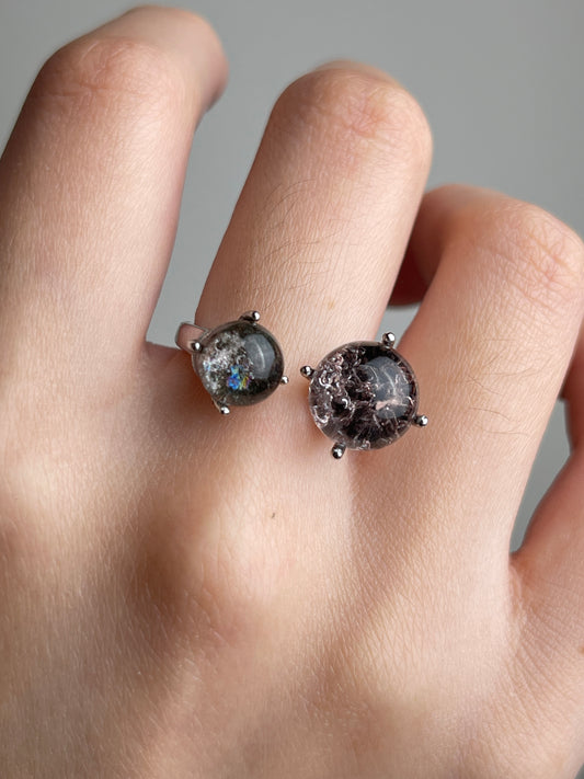 Close-up of Phantom Quartz twin stone ring worn on hand