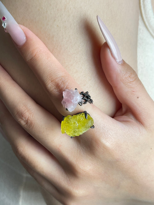 Pink Strawberry Quartz and yellow Brucite crystal ring worn on hand close up