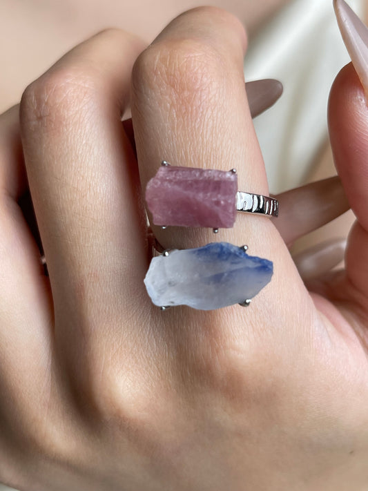 Close-up hand shot of raw pink tourmaline and dumortierite quartz ring