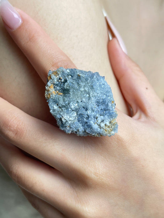 Close-up of Raw Blue Sapphire Mineral Specimen Ring worn on hand