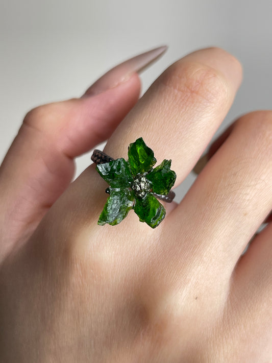 Close-up of Raw Chrome Diopside and Chalcopyrite flower ring worn on hand
