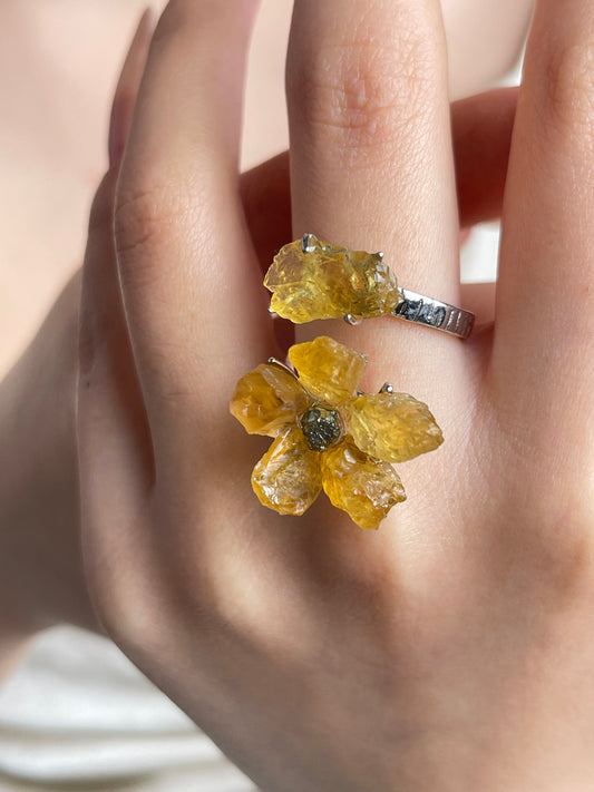 Close-up hand shot of raw citrine flower ring with chalcopyrite