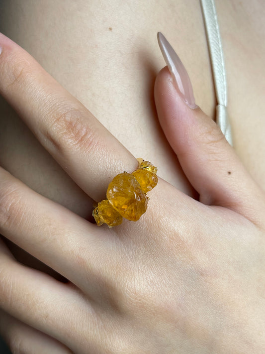 Raw citrine crystal ring worn close up