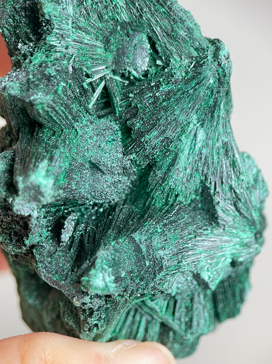 Detail of natural fibrous malachite with needle-like green crystal texture