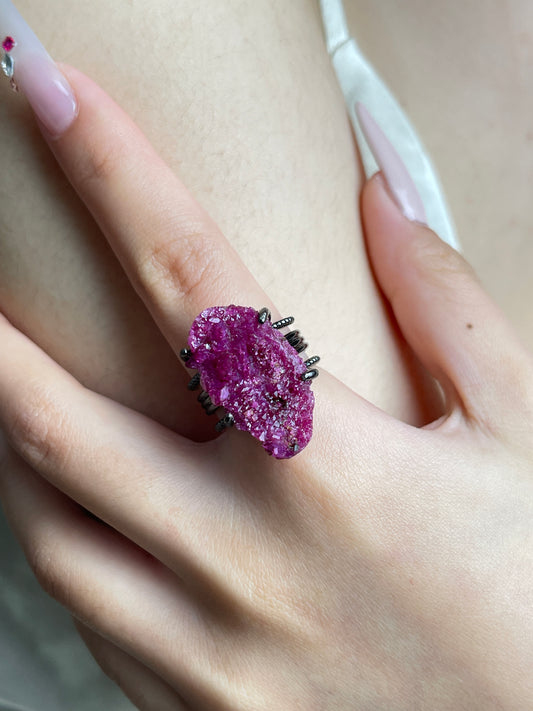 Close-up of Raw Ruby Red Corundum mineral specimen ring worn on hand