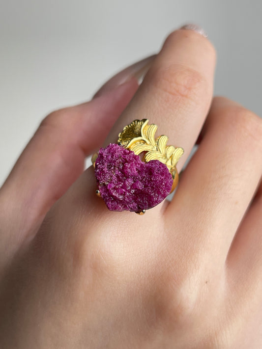 Close-up of Raw Ruby Red Corundum mineral specimen ring worn on hand