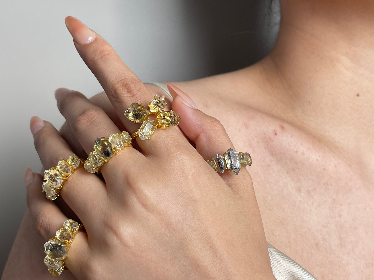 Herkimer-Diamond-Quartz-rings-on-hand-shoulder