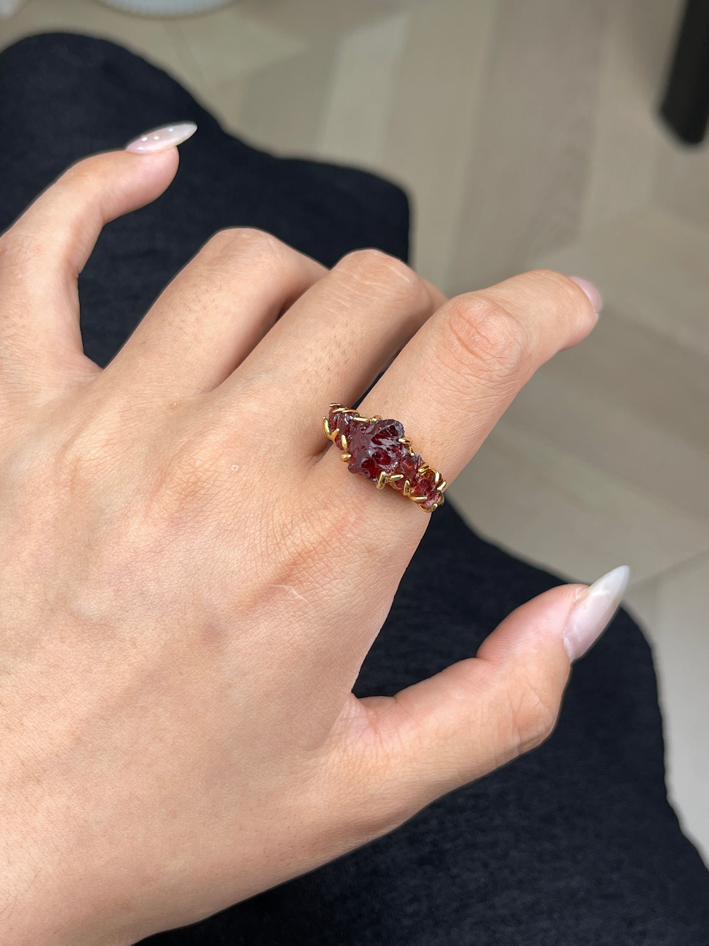 Raw garnet ring worn close up detail