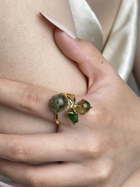Close-up hand shot of actinolite quartz, phantom quartz and chrome diopside ring showing natural inclusions