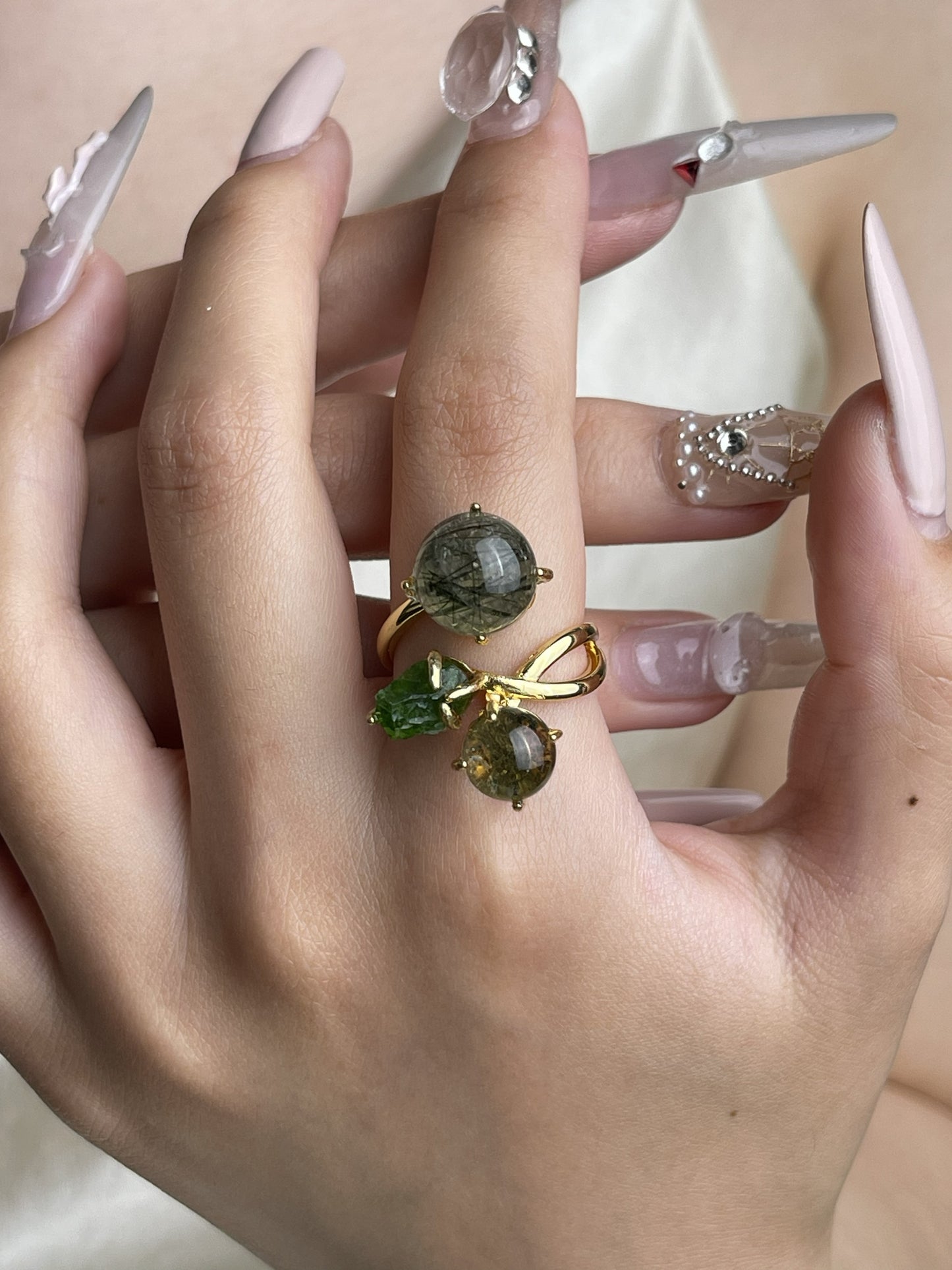 Actinolite quartz, phantom quartz and chrome diopside ring worn on hand with green natural crystal accents