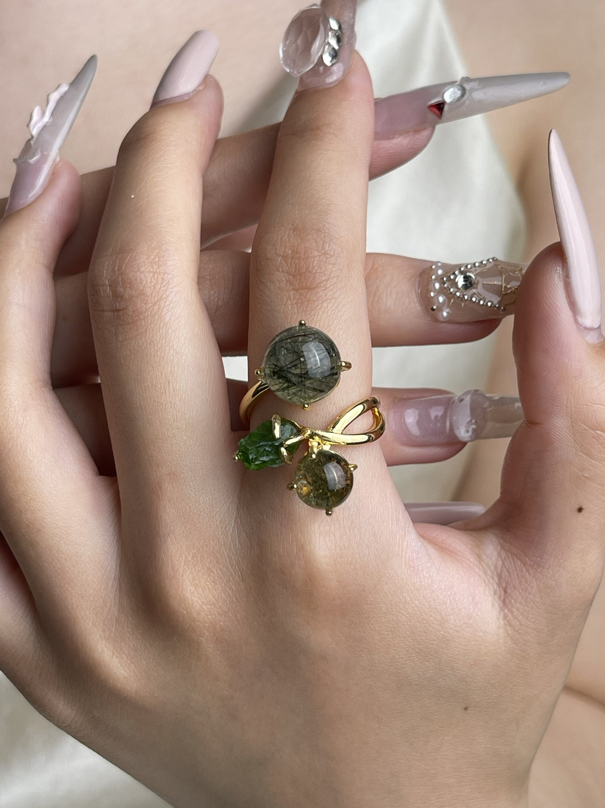 Actinolite quartz, phantom quartz and chrome diopside ring worn on hand with green natural crystal accents