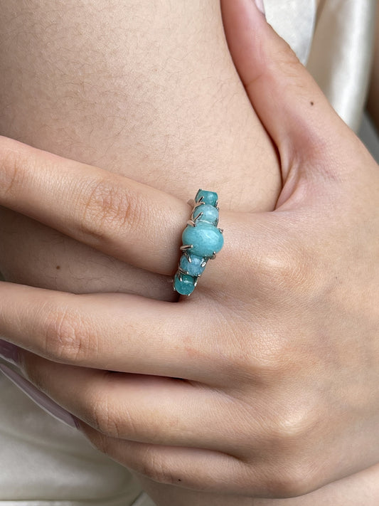 Close-up hand shot of amazonite band ring showing soft blue green feldspar stones