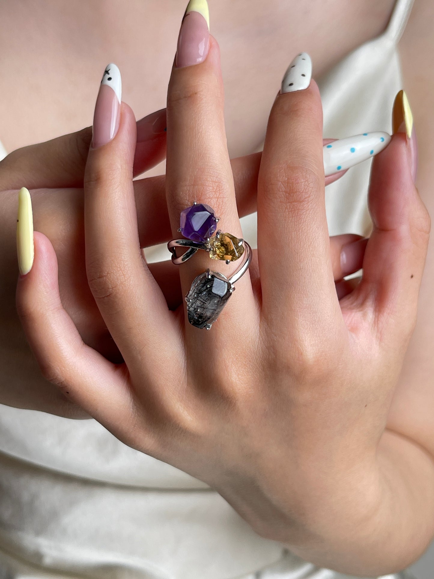 Amethyst, citrine and black tourmalinated quartz crystal ring worn on hand