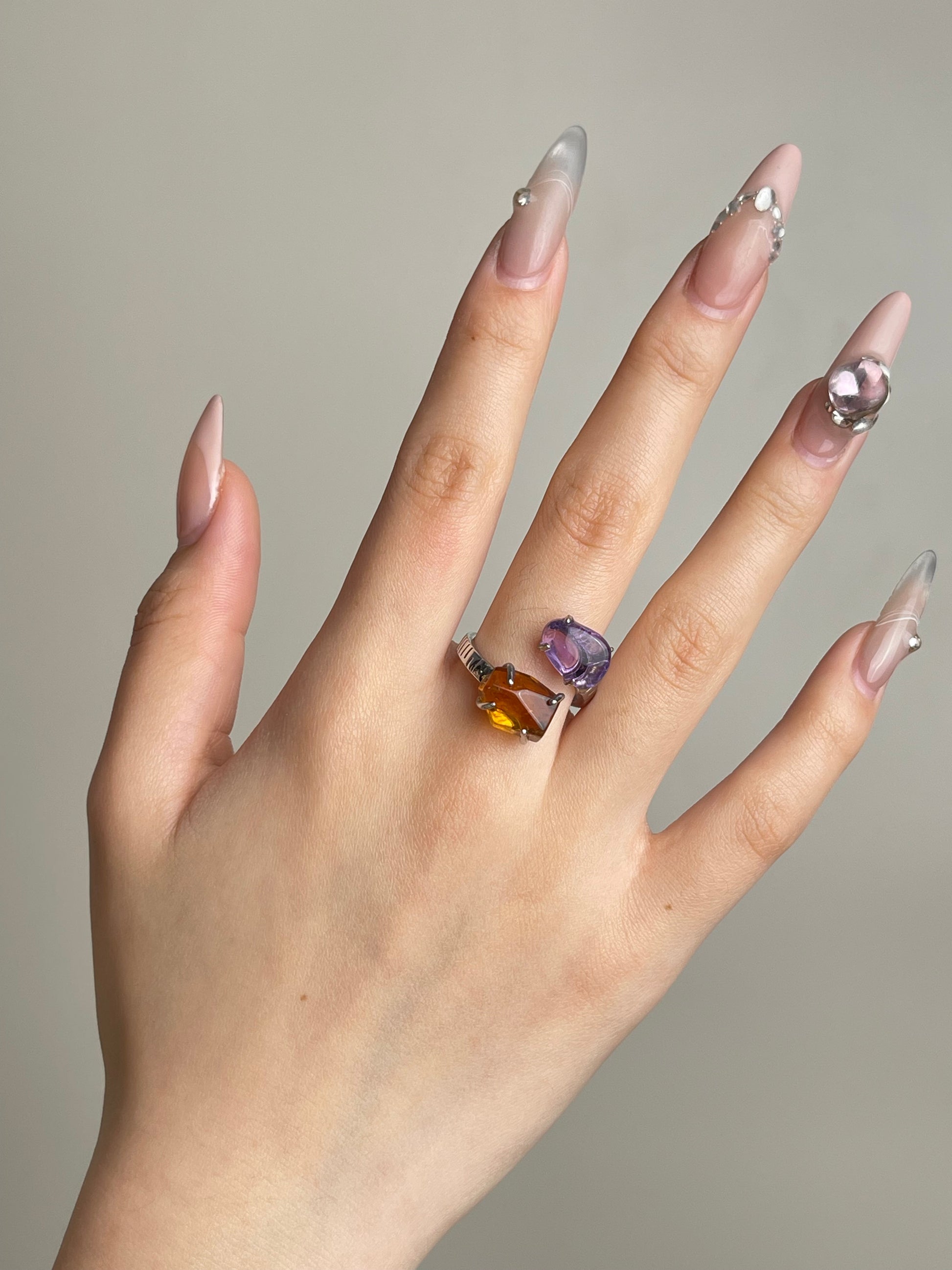Amethyst and citrine crystal ring worn on hand in silver finish