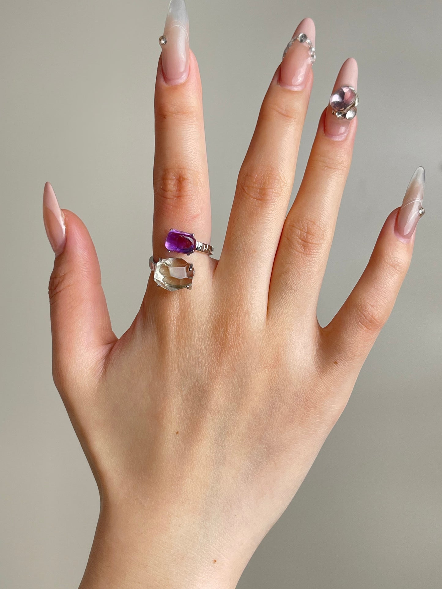 amethyst and green quartz twin ring worn on hand