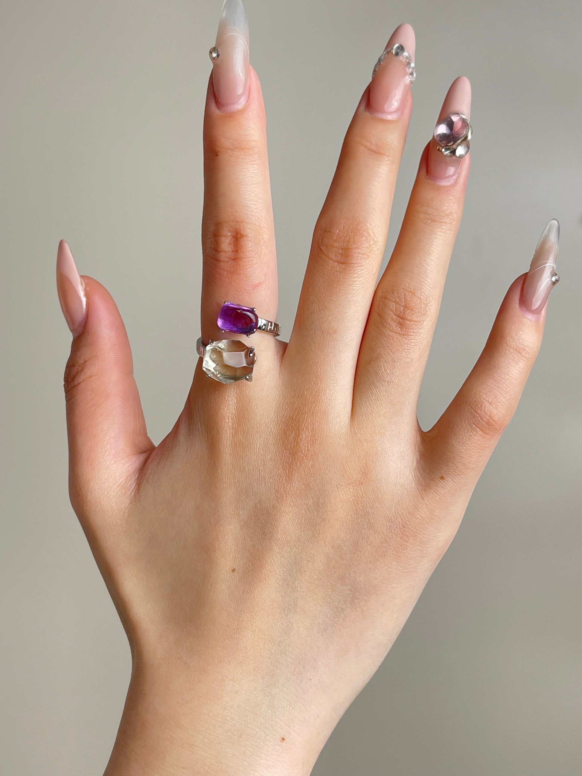 amethyst and green quartz twin ring worn on hand