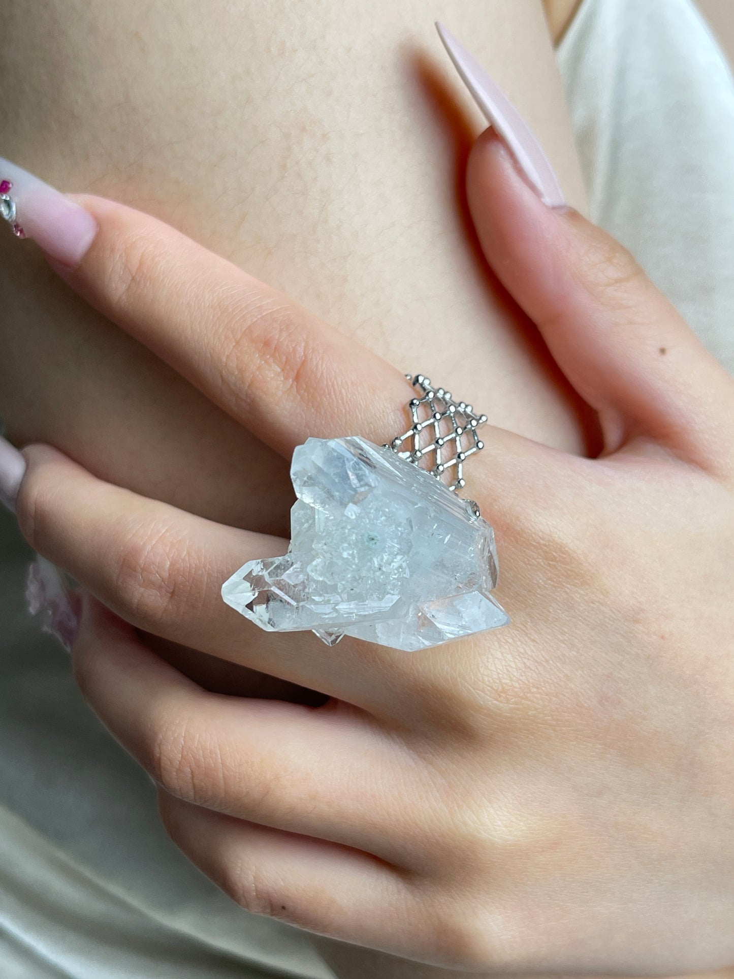 Close-up of Apophyllite crystal cluster ring worn on hand