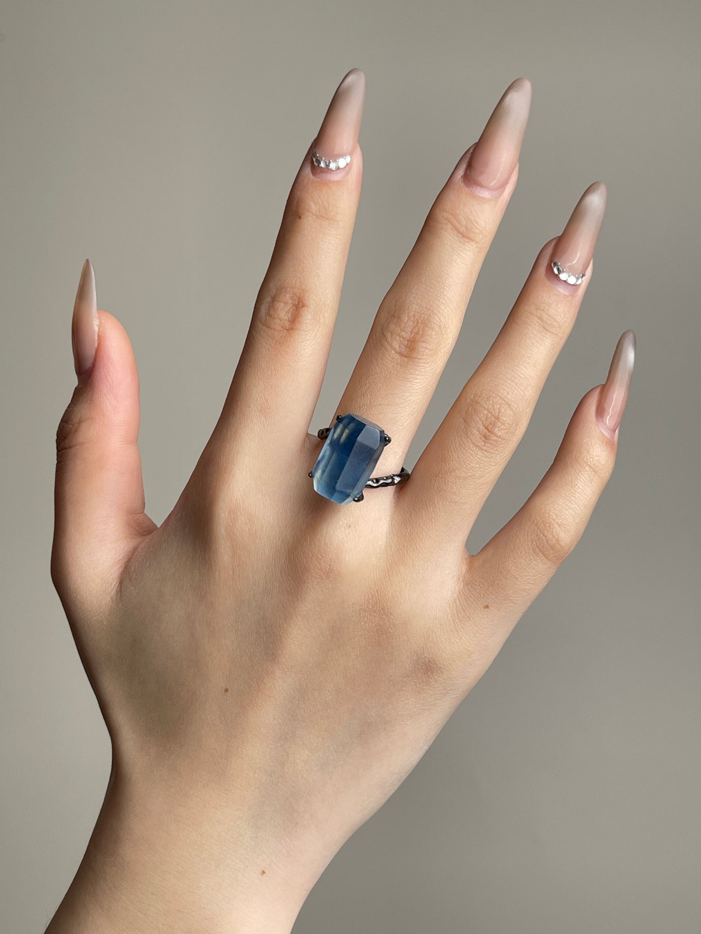 Aquamarine freeform ring worn on hand