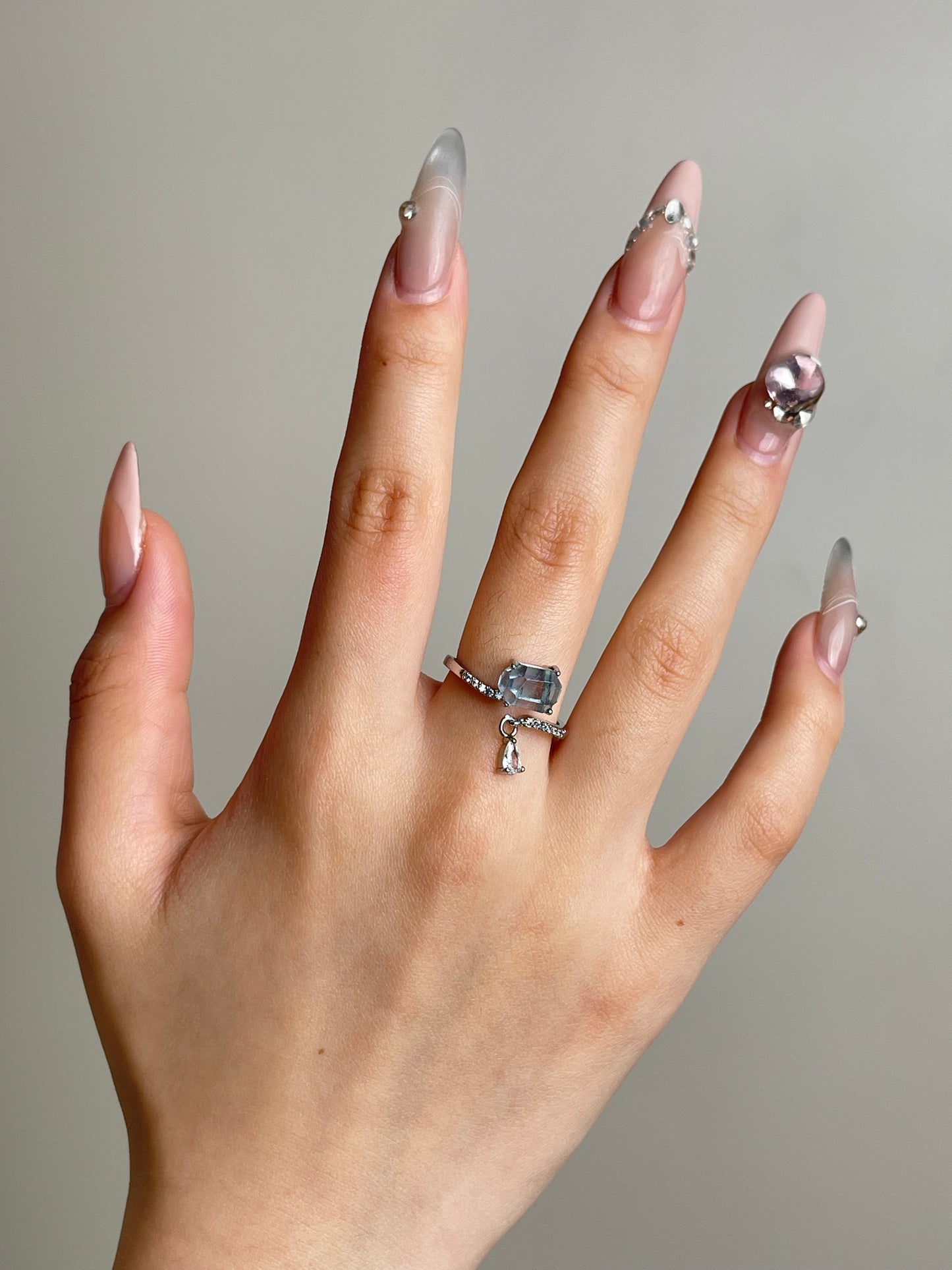 Aquamarine ring worn on hand with soft ocean blue tone