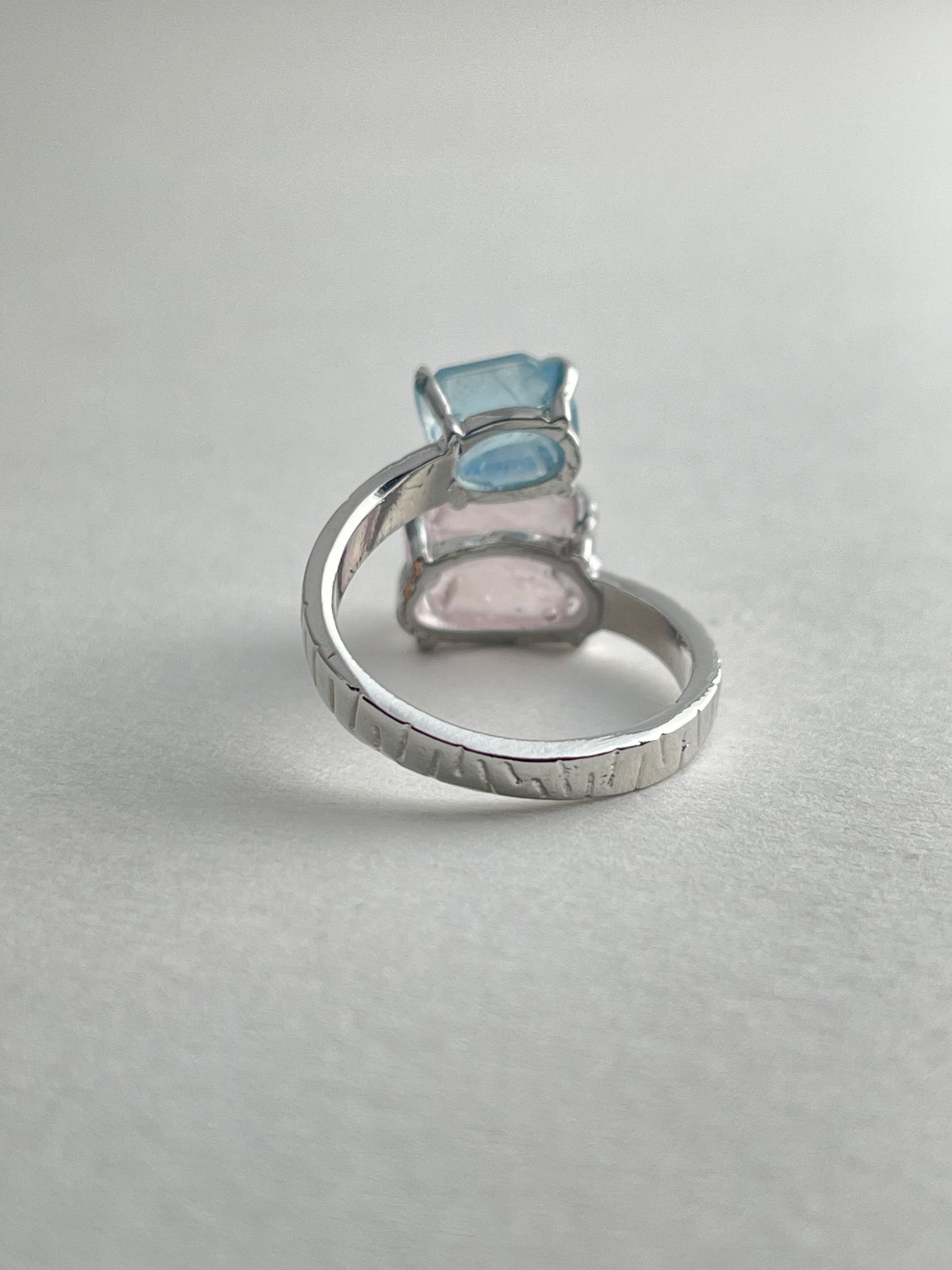 Back view of Aquamarine and Morganite twin stone ring with open band design
