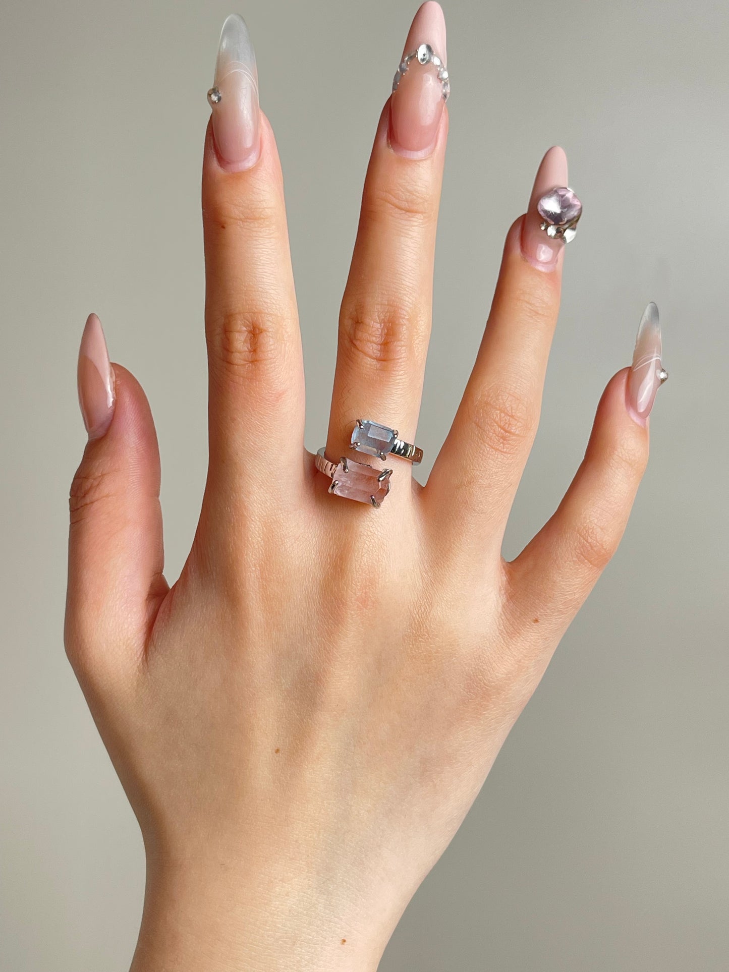 Aquamarine and Morganite twin stone ring worn on hand in silver tone finish