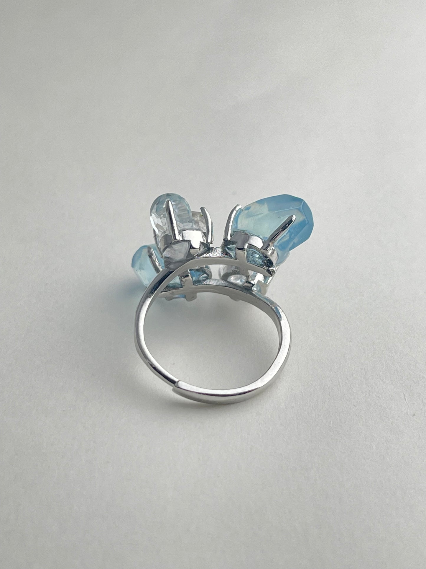 Back view of aquamarine ring adjustable band with blue topaz and Hakima Diamond quartz
