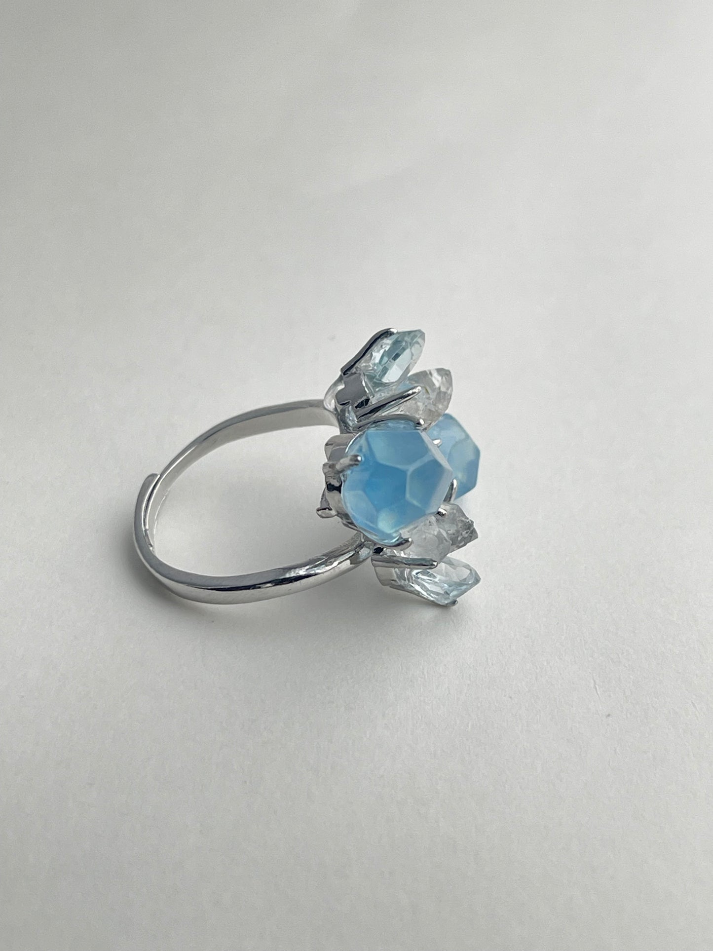 Side view of aquamarine ring with blue topaz and Hakima Diamond quartz natural crystal jewelry