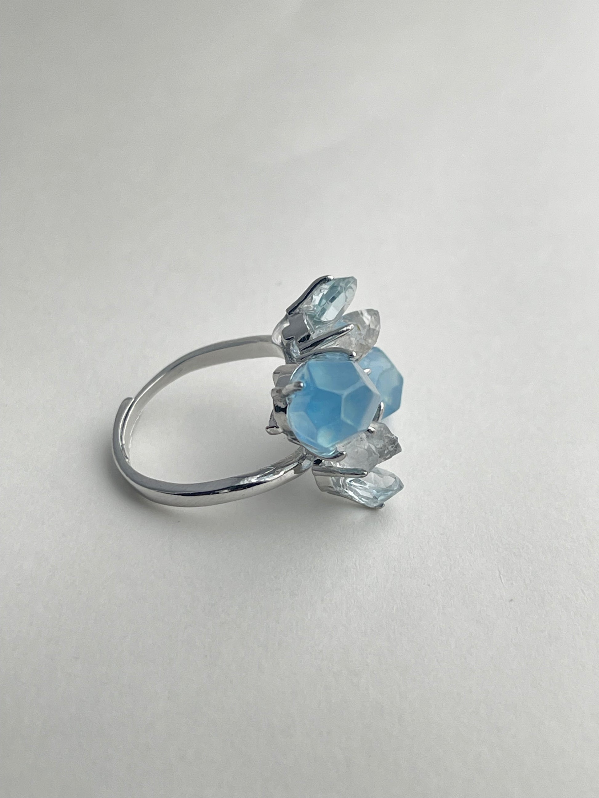 Side view of aquamarine ring with blue topaz and Hakima Diamond quartz natural crystal jewelry
