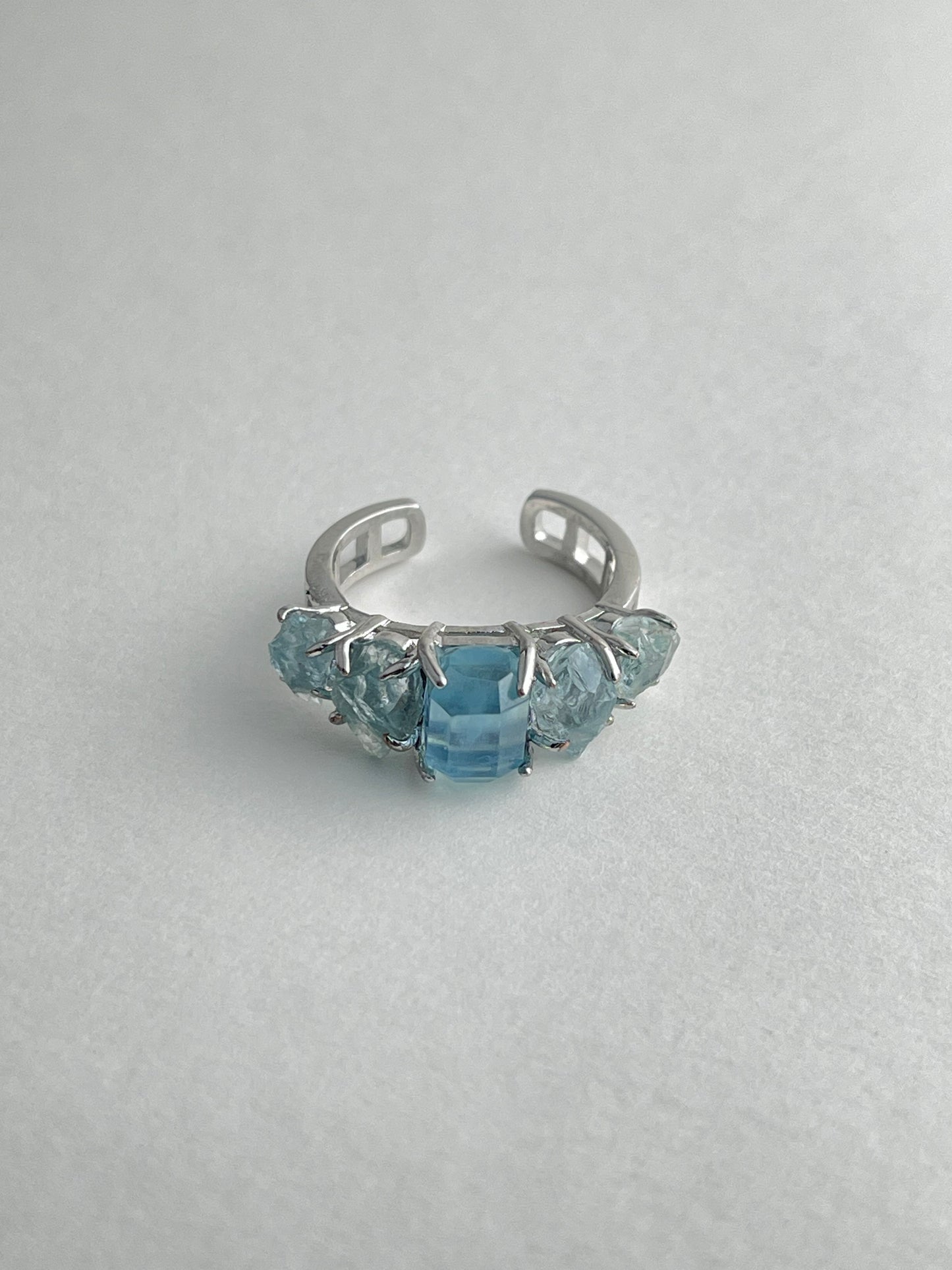 Aquamarine row ring with hand cut aquamarine and raw aquamarine from Brazil natural crystal jewelry front view