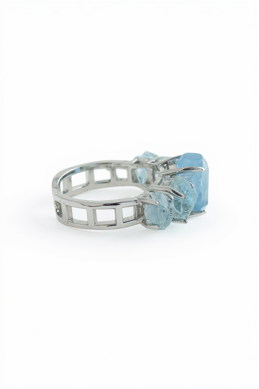 Side view of aquamarine row ring showing hand cut and raw aquamarine crystal structure
