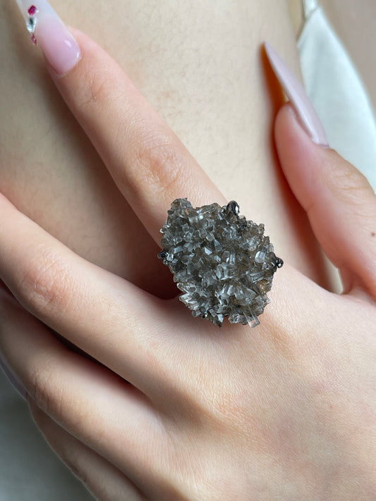 Close-up hand view of Aurora Calcite cluster mineral specimen ring.