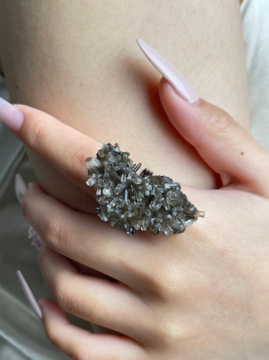 Close-up hand view of Aurora Calcite cluster mineral specimen ring.