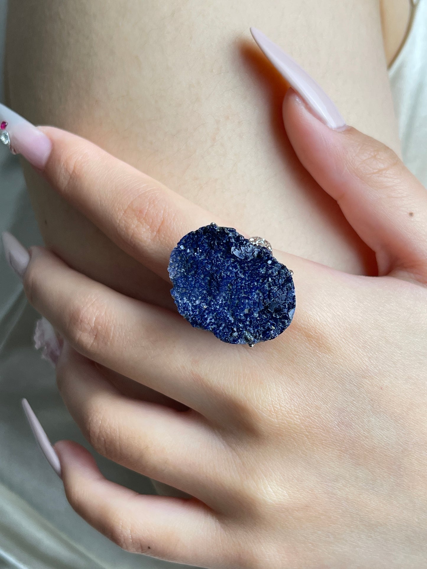 Close-up of Raw Blue Sapphire Crystal Ring worn on hand