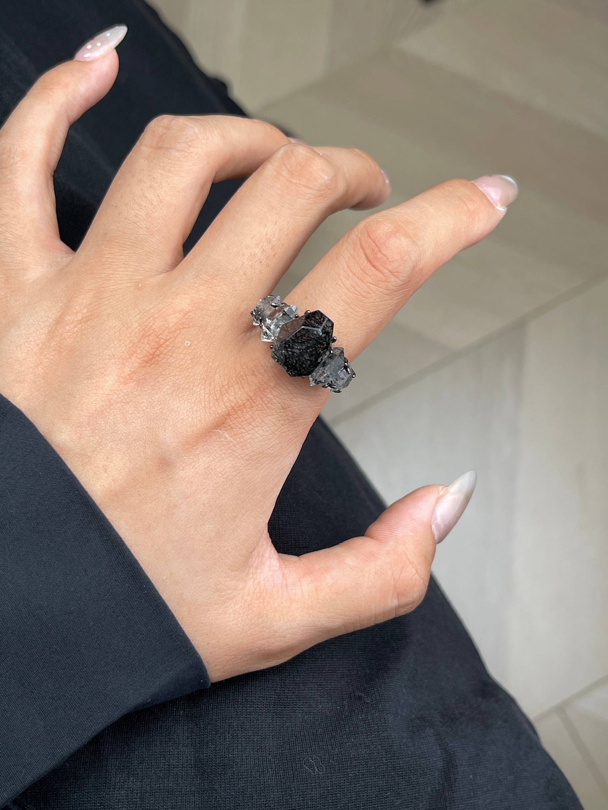 Close-up hand shot of Black Rutilated Quartz and Hakima Diamond Quartz ring