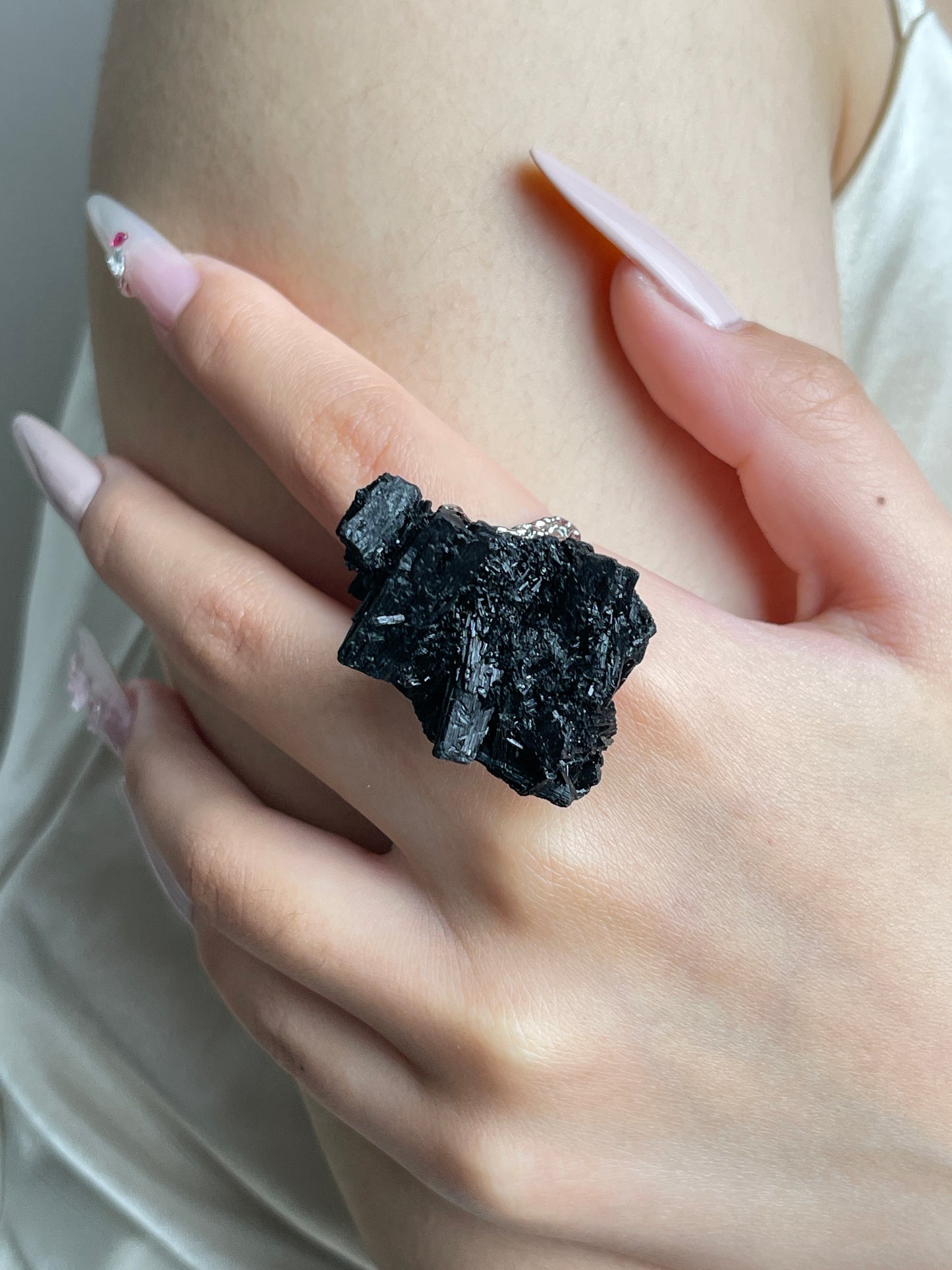 Close-up of Black Tourmaline Cluster mineral specimen ring worn on hand