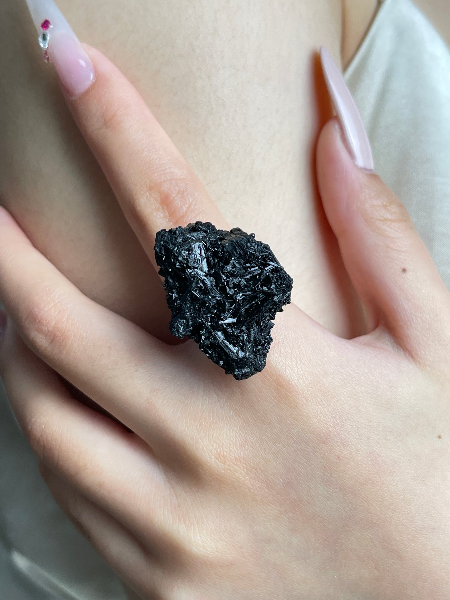Close-up of Black Tourmaline Cluster mineral specimen ring worn on hand