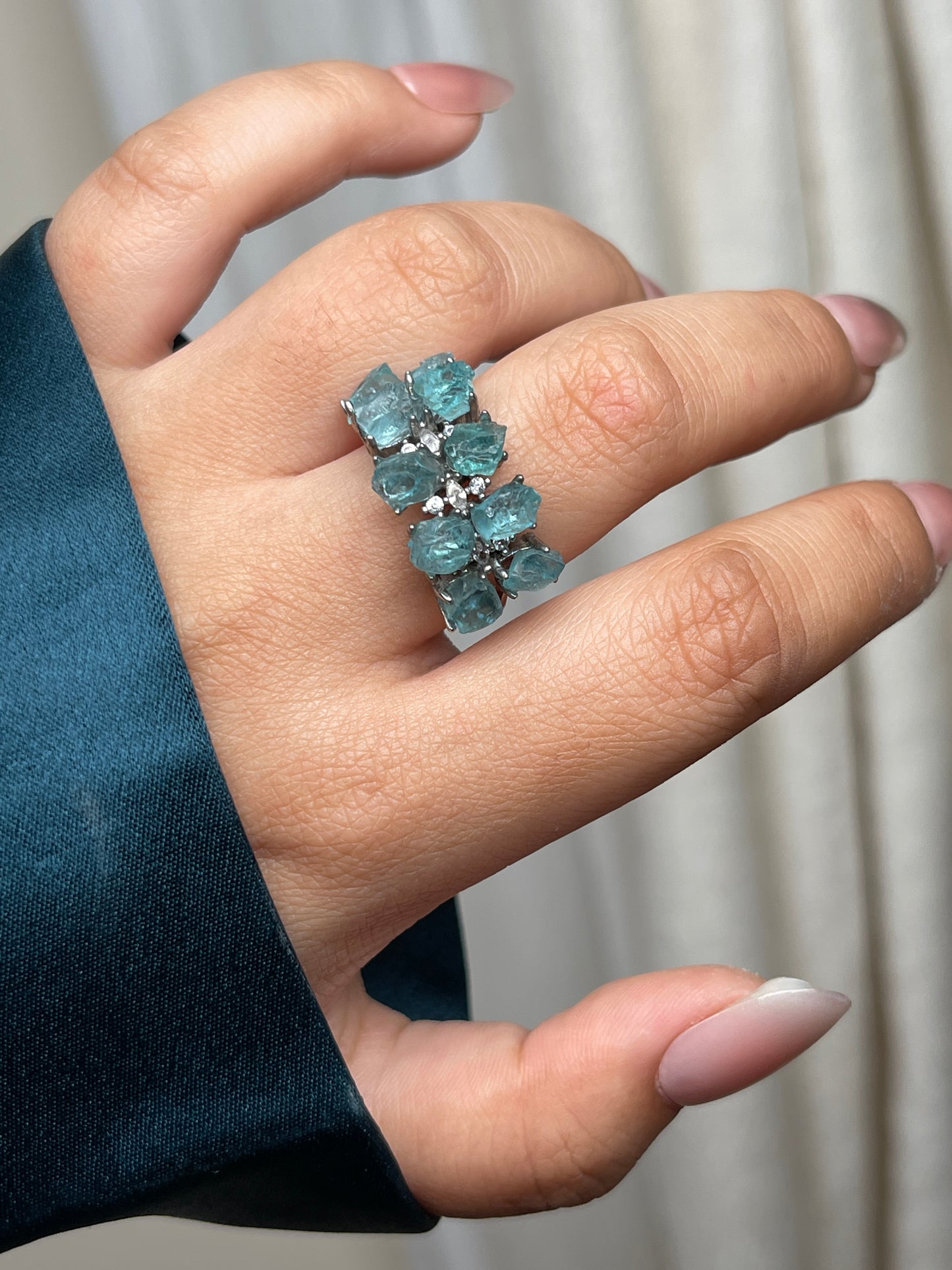 close up of blue apatite double row ring showing vivid blue crystals